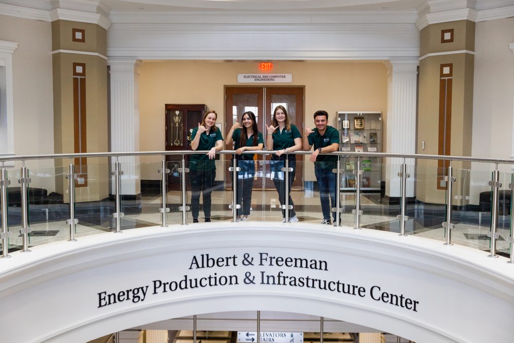 Students posing at top of staircase